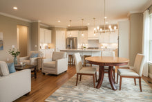 Load image into Gallery viewer, round two tone cherry table with legs in a home